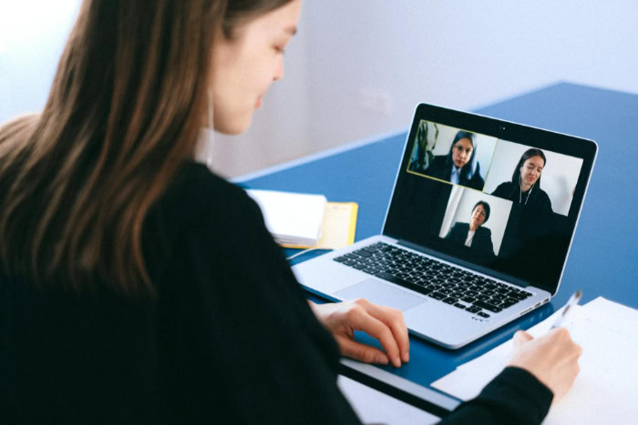 Woman attending a virtual meeting on a laptop