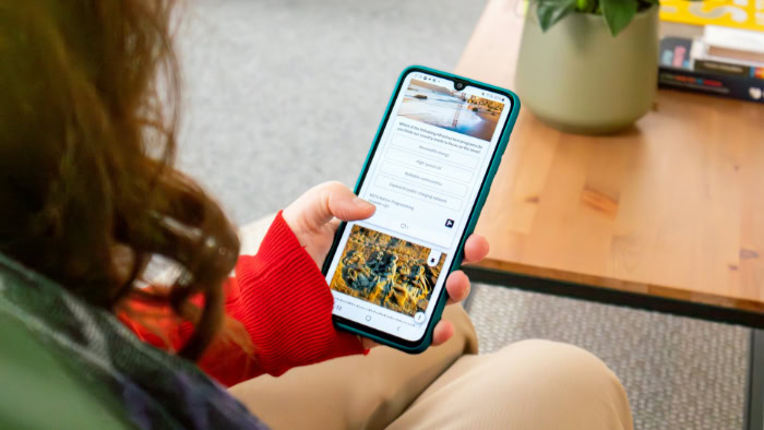 Woman browsing on a smartphone indoors