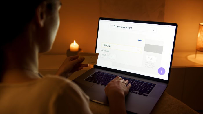 Woman entering credit card details for online checkout resized