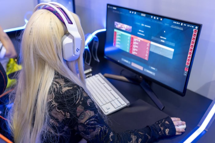 Woman gaming on a PC with headphones