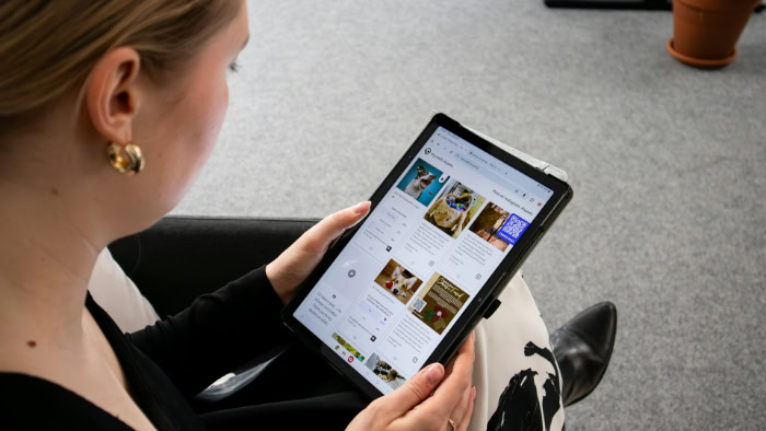 Woman holding galaxy tablet browsing website content