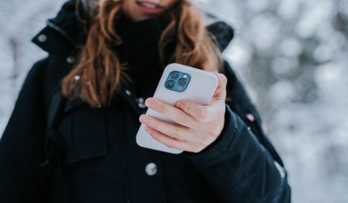 Woman holding white iPhone