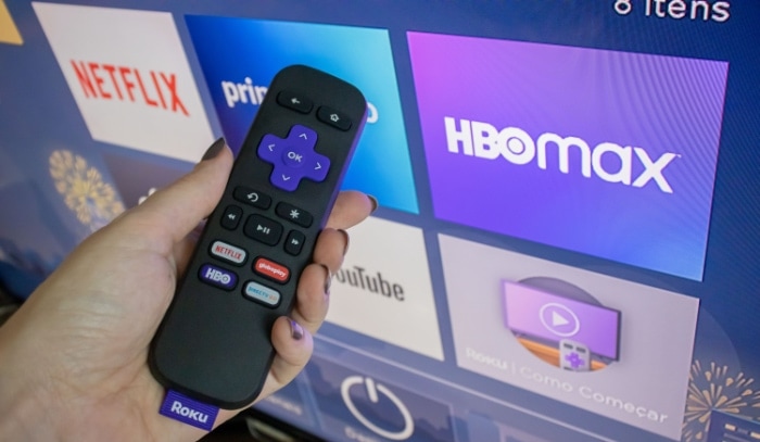 Woman holding roku remote