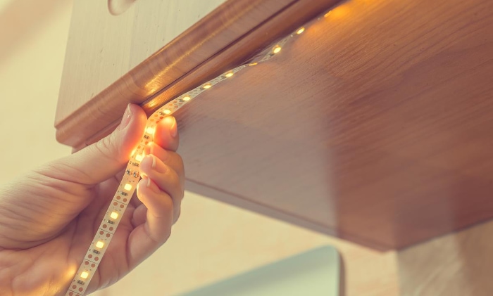 Woman installing LED strip