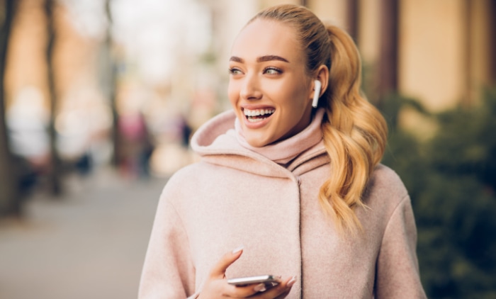 Woman listening music on her airpods