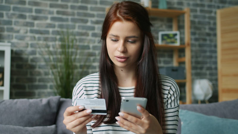 Woman making online payment with credit card