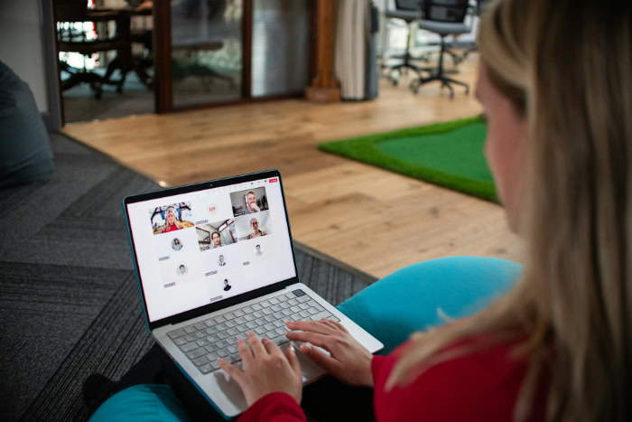 Woman on laptop joining remote video meeting
