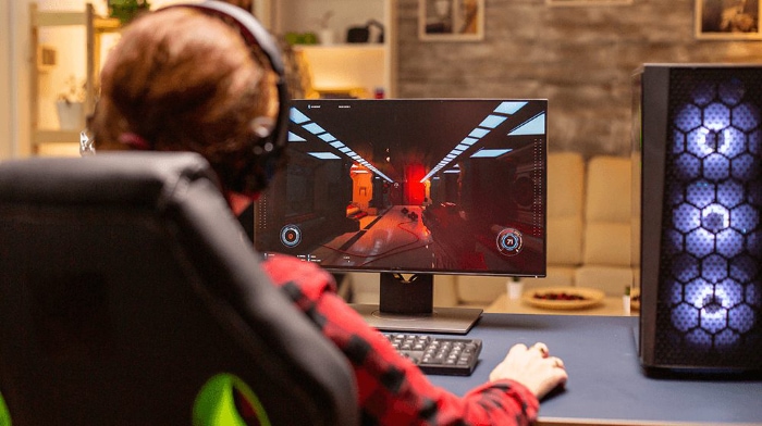 Woman playing video games on PC