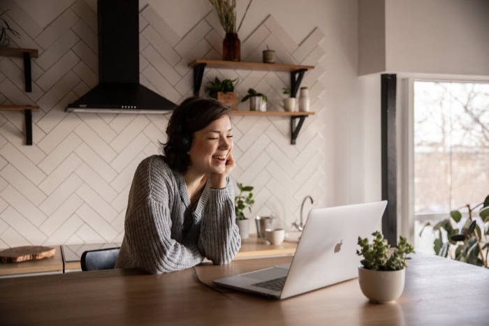 Woman smiling during a video call on a laptop