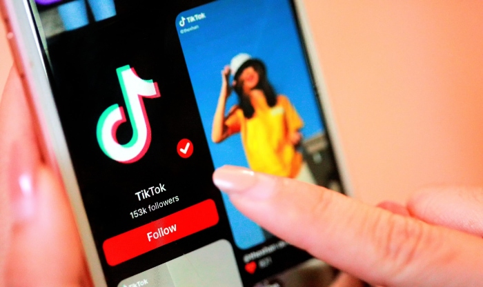 Woman using TikTok on smartphone