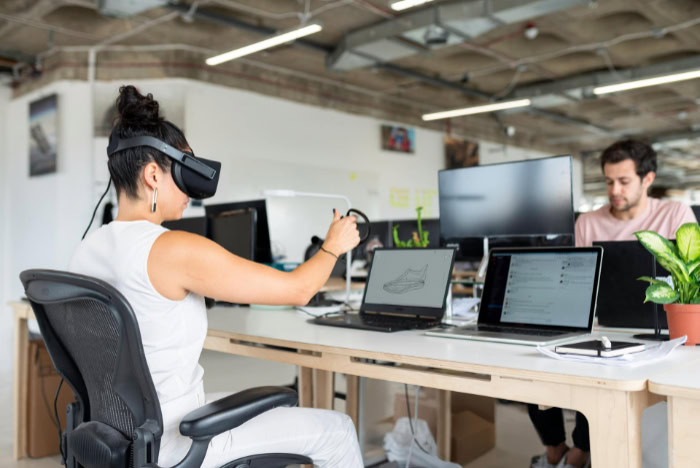 Woman using VR headset for 3D design work