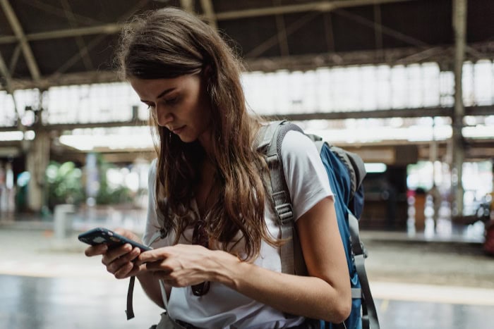 Woman using a smartphone at a train station