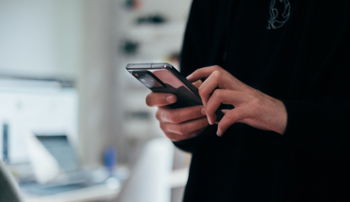 Woman using black smartphone 1