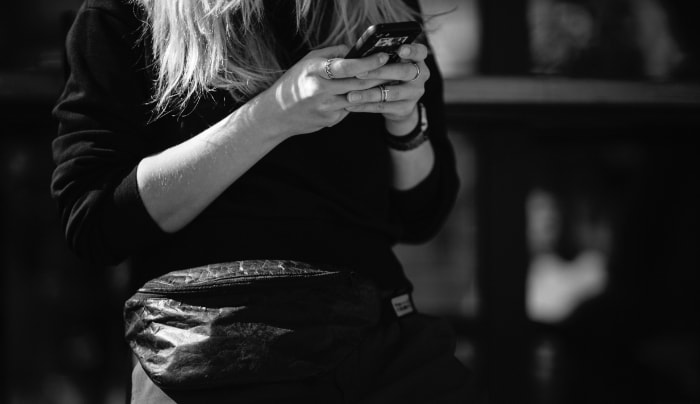 Woman using black smartphone