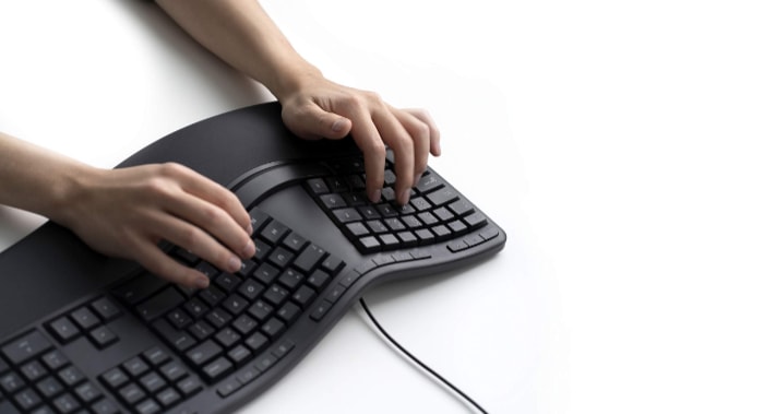Woman using ergonomic keyboard