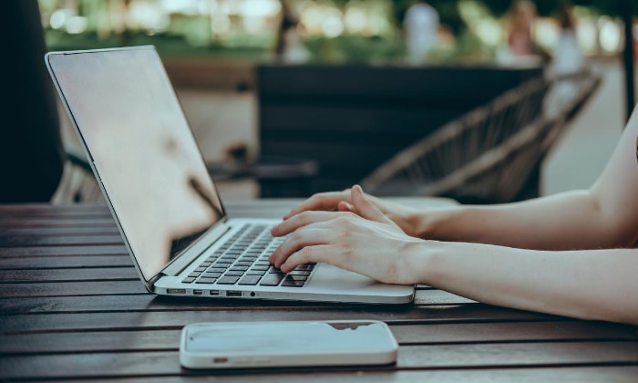 Woman using macbook on table