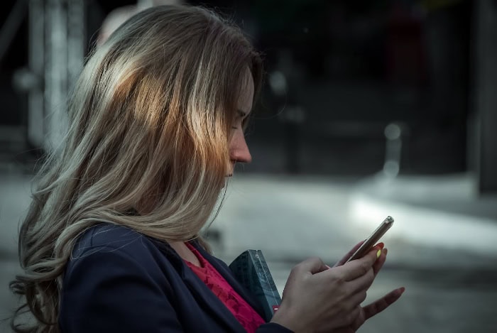 Woman using smartphone at night