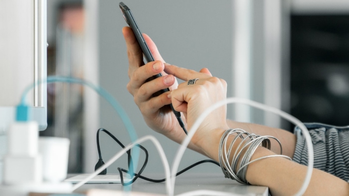 Woman using smartphone while charging