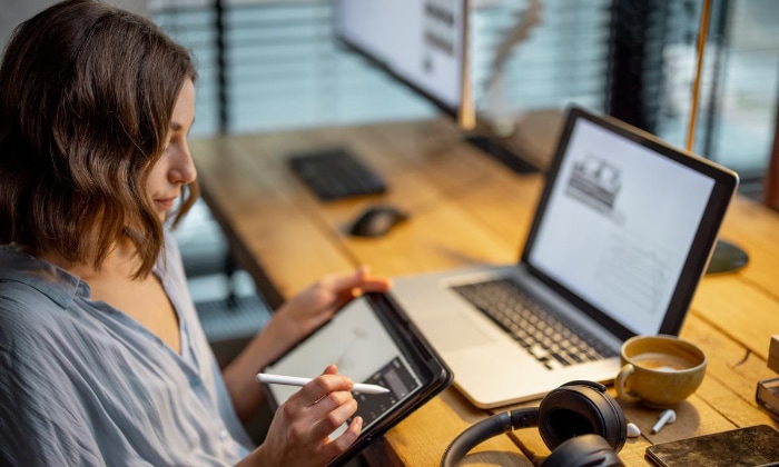 Woman using stylus on tablet