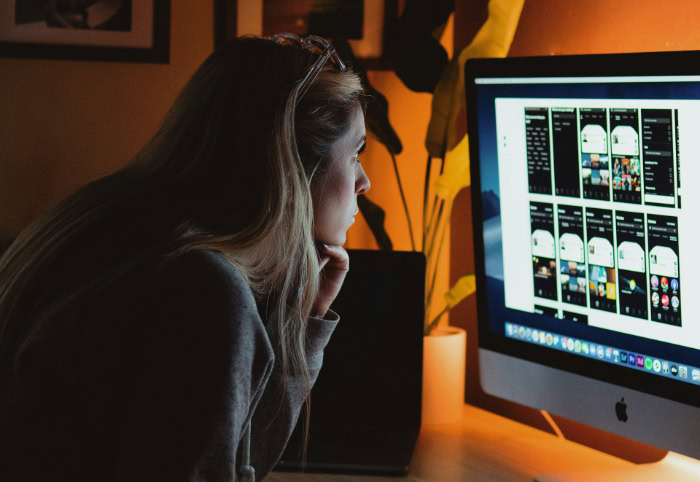 Woman working late at home office at night