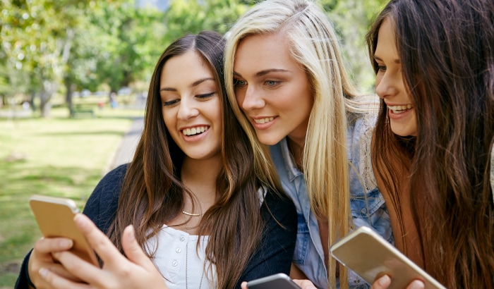 Women watching viral video on iphone