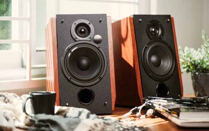 Wooden bookshelf speakers with black front on table