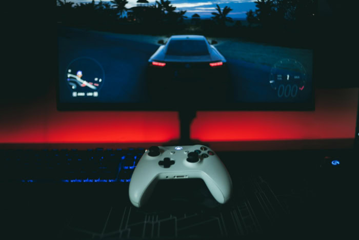 Xbox controller in front of a gaming monitor