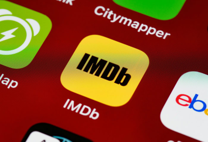Yellow IMDb mobile app icon on smartphone screen