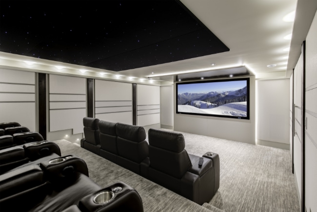 black home theater seats facing on projector screen