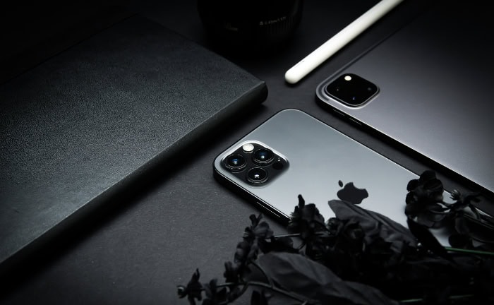 iPhone 11 Pro with triple lens camera on dark minimalist background