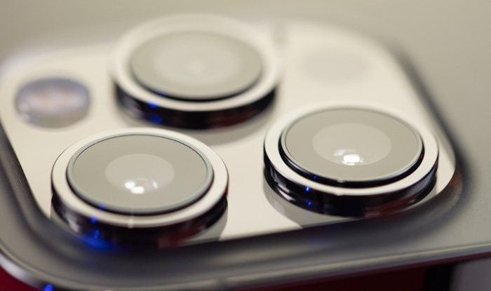 Close-up of iPhone Pro camera lenses in silver finish