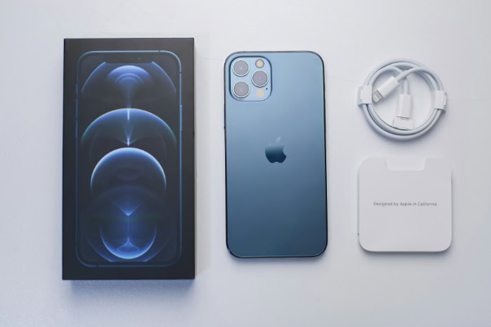 iPhone 12 Pro box and accessories flat lay