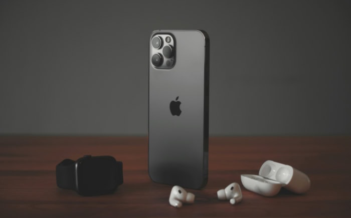 iPhone 12 Pro with wireless earbuds on table