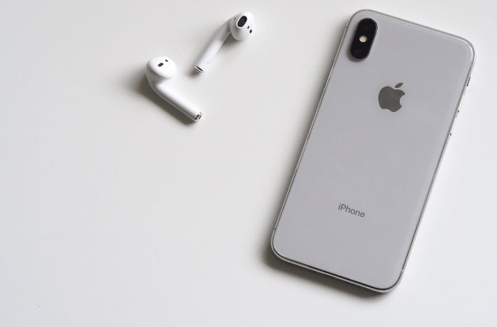 iPhone and AirPods on white background