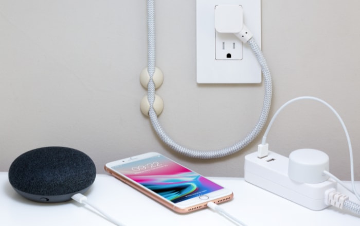 iPhone charged on white desk