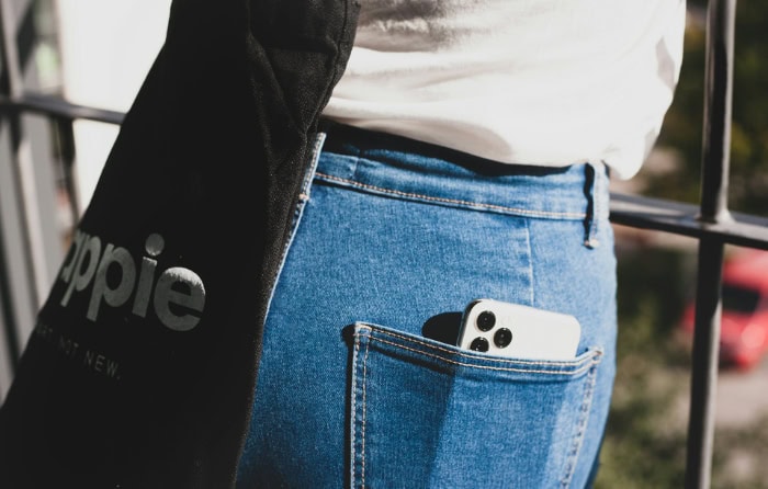 iPhone in the back pocket of blue jeans