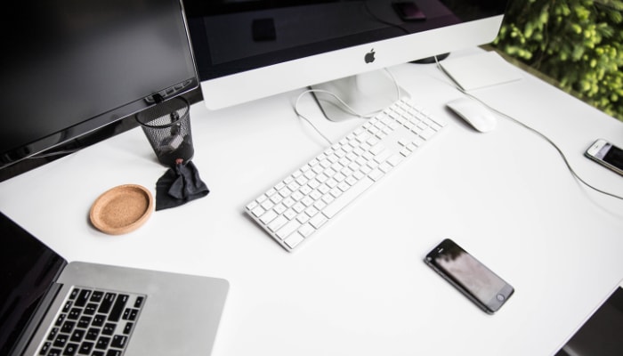 iphone 6 on table near magic keyboard