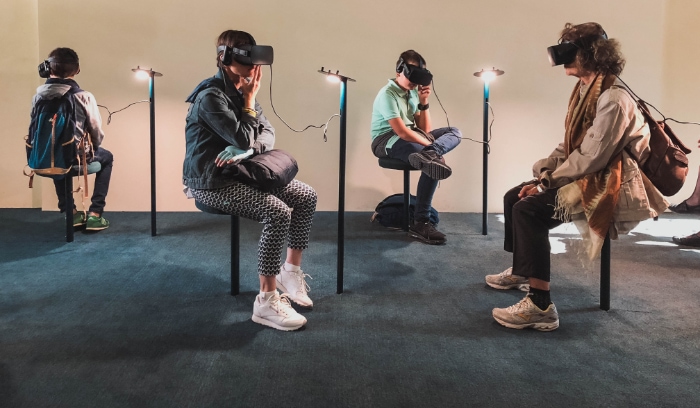 People wearing black virtual reality